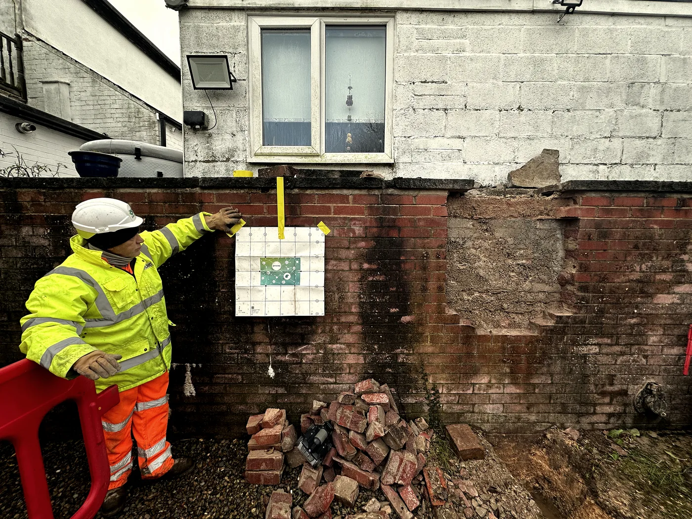 Surveyor pointing to scan markings on a wall