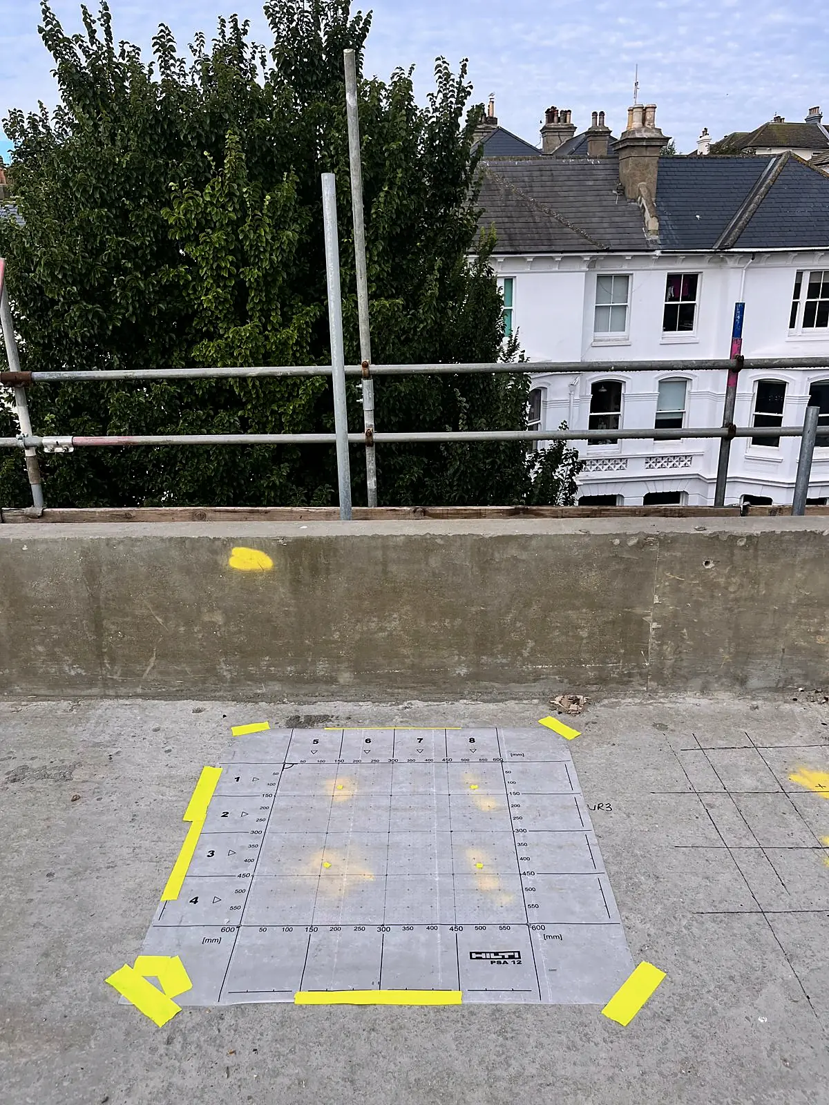 Scan grid taped out on a roof slab with spray marks, Brighton