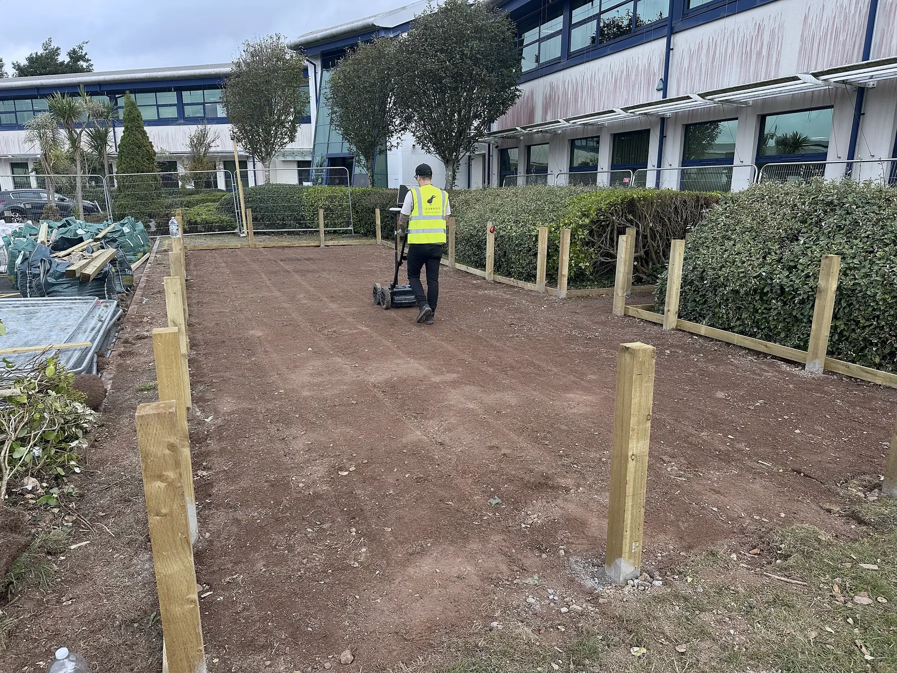 Ground GPR cart survey over a cleared works area outside an office building