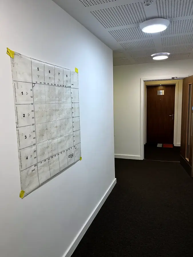 Scan grid fixed to a corridor wall in an occupied residential block