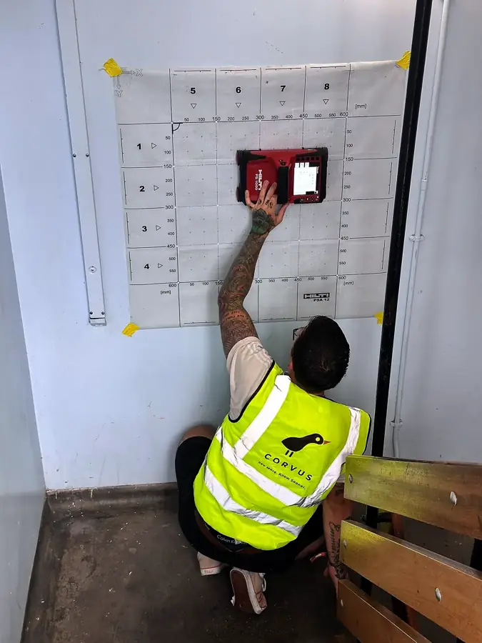 Corvus surveyor scanning a wall in a high-rise housing block