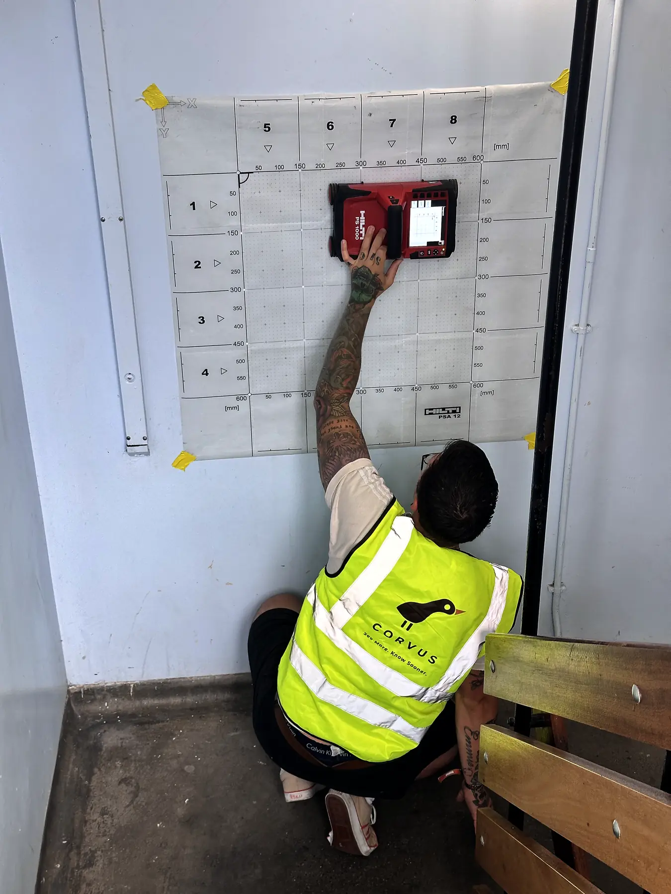 Corvus surveyor scanning a stairwell wall through a grid sheet
