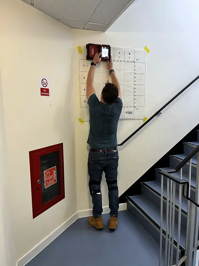 Scanning high on a stairwell wall